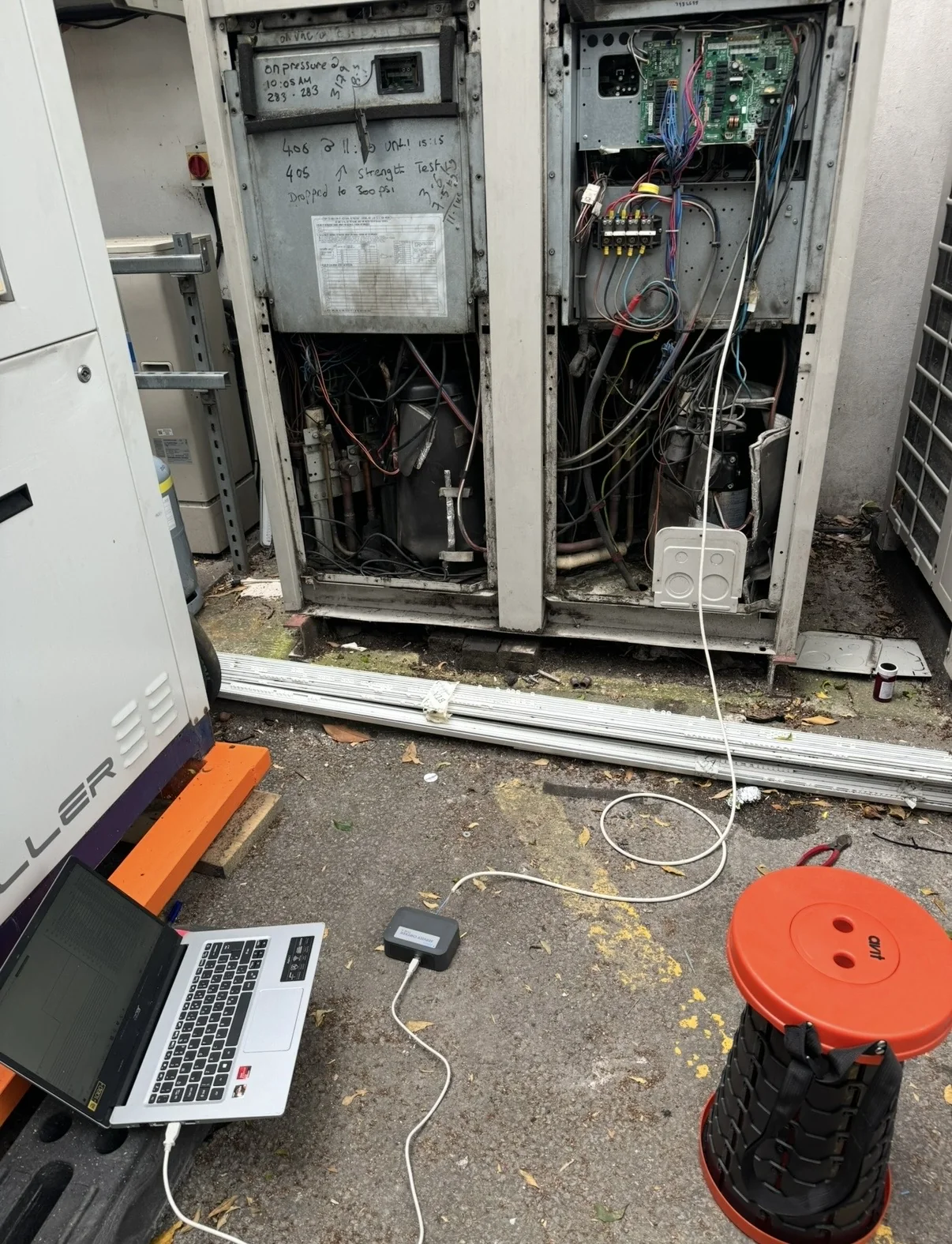 Laptop connected to commercial air conditioning equipment for technical fault diagnosis