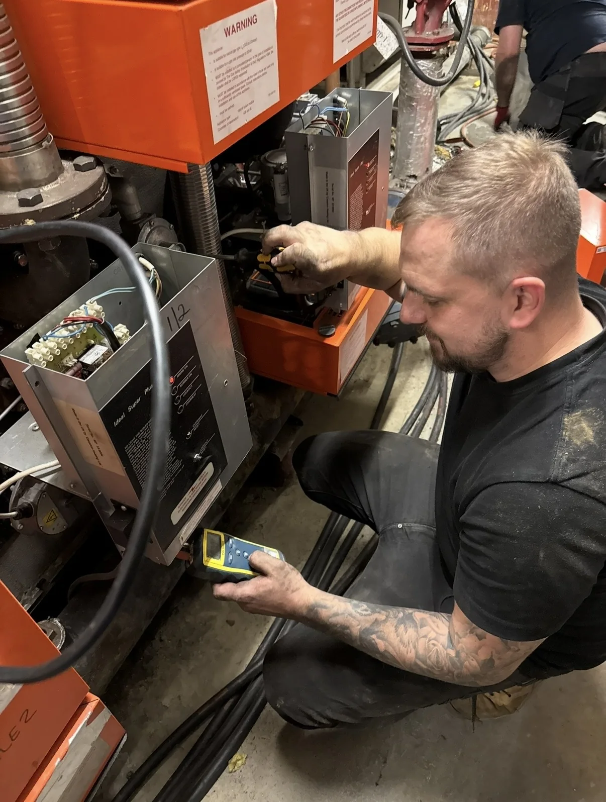 Engineer carrying out servicing and testing on mechanical equipment