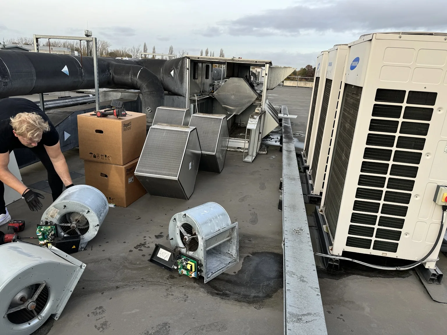 Engineer working on rooftop ventilation fans and air handling equipment